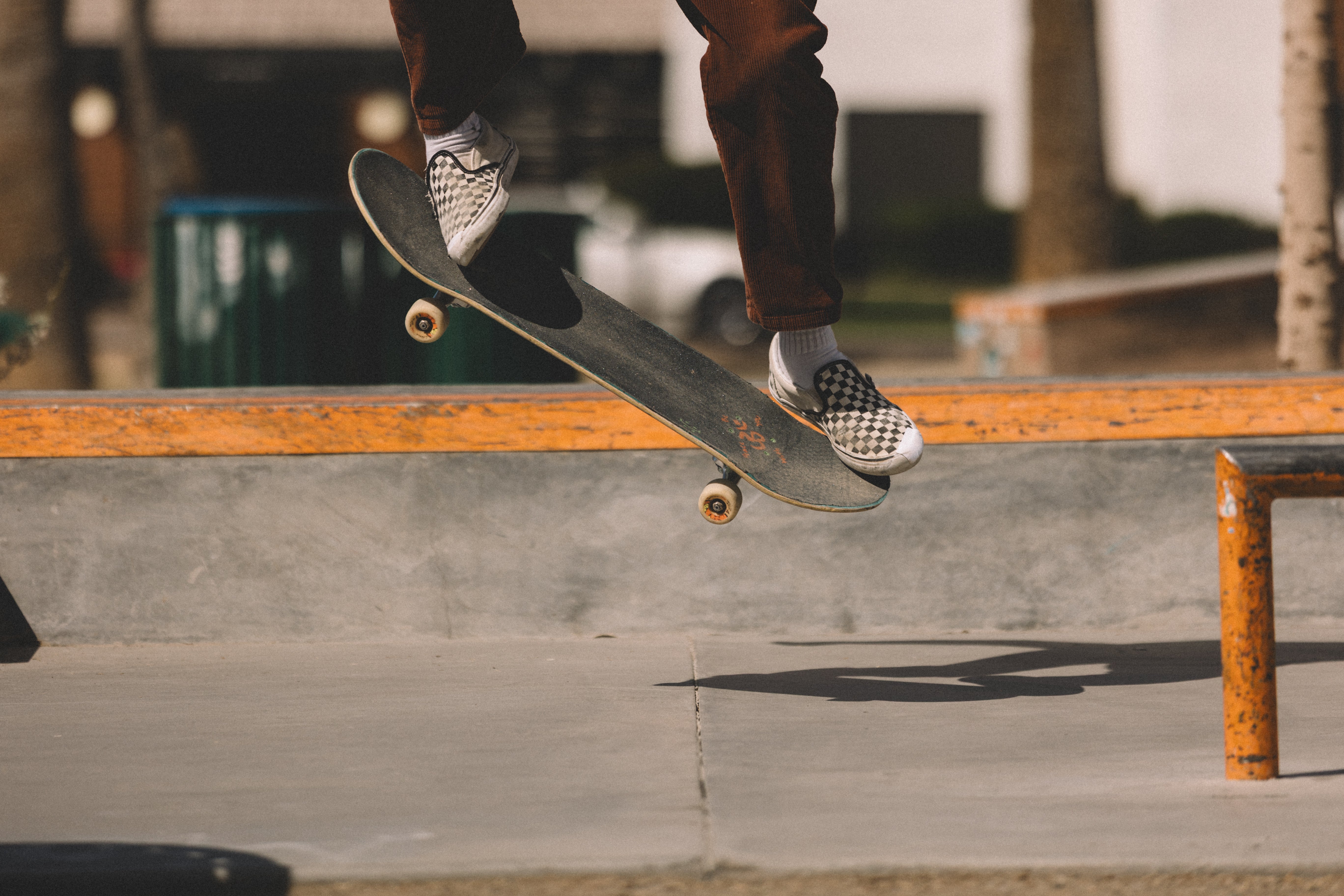 Skater ollieing using TrickTape and checkered shoes