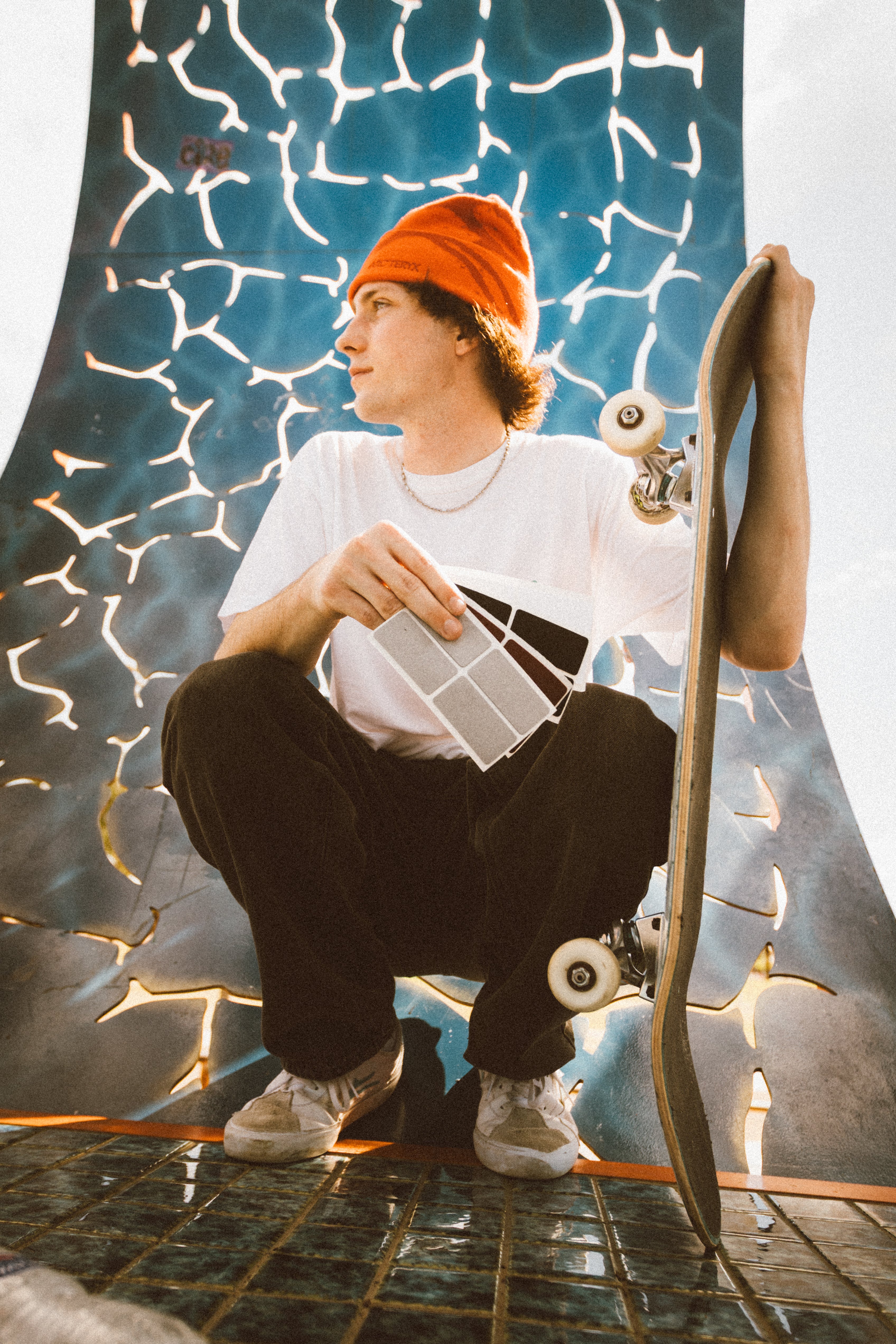 Skater holding TrickTape patches textured wall in the background
